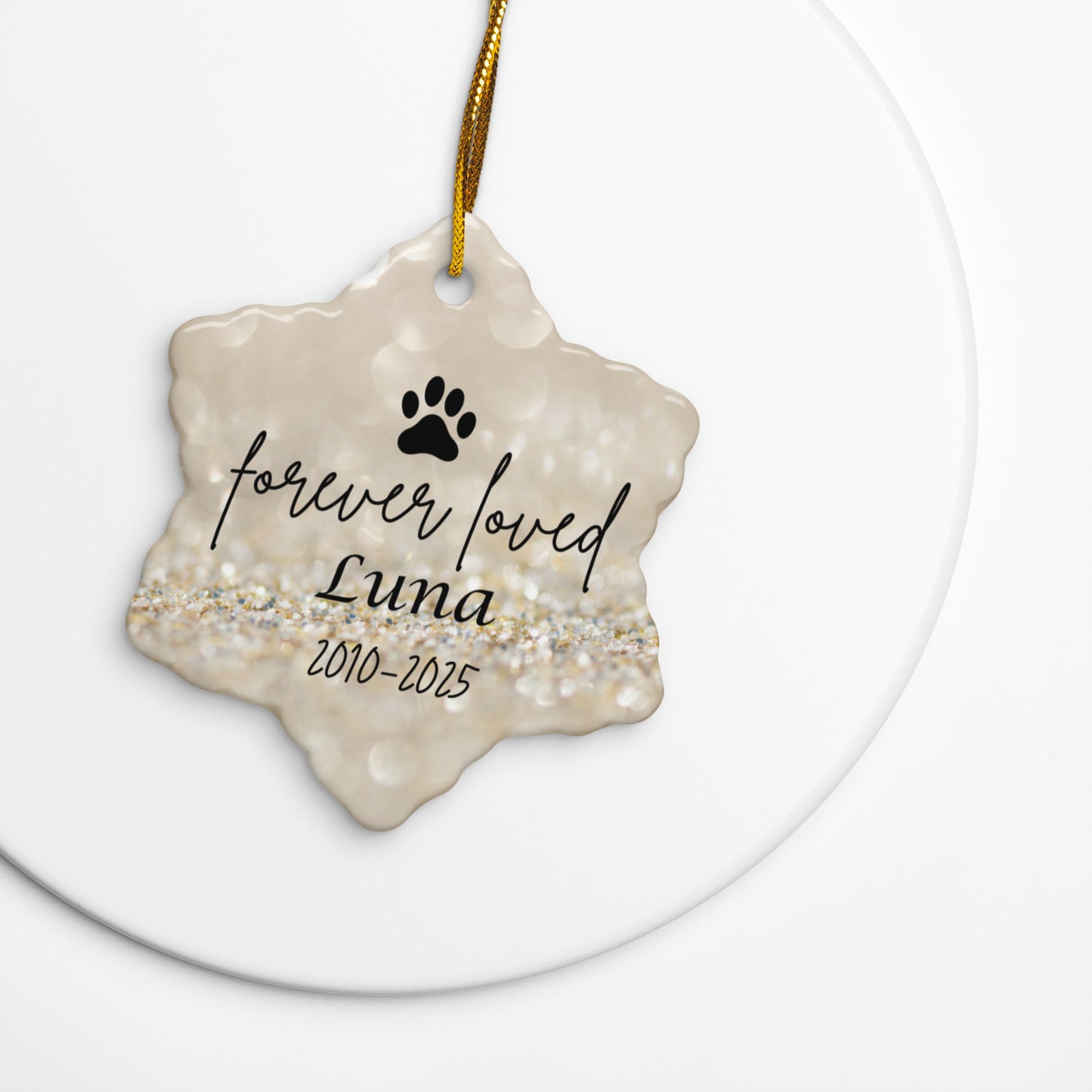 Decorative pet memorial ornament with 'forever loved Luna' text on a gold background