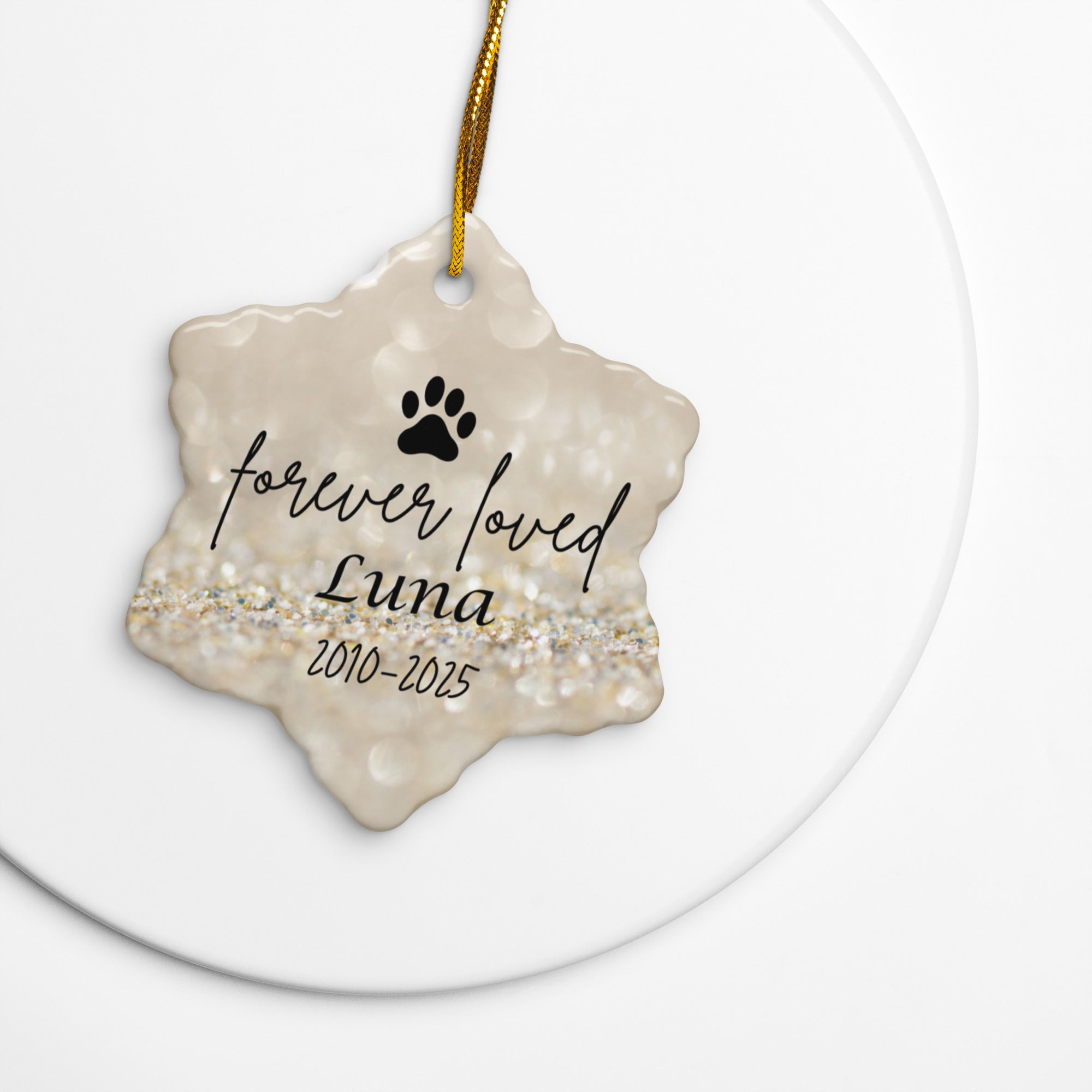 Decorative pet memorial ornament with 'forever loved Luna' text on a gold background