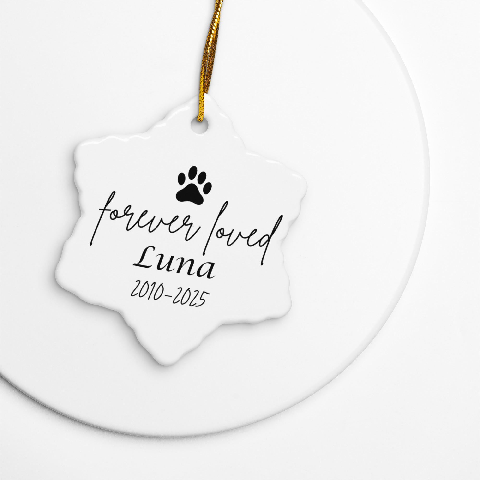 White pet memorial ornament with paw print and text on a white background
